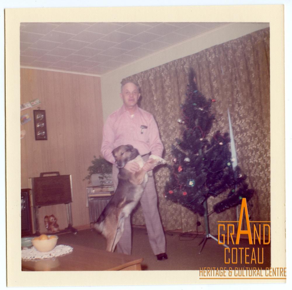 Photographic print, Joe Richtik with dog in his living room at Christmas