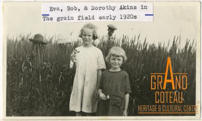 Photograph, Eva and Dorothy Akins, and their father Robert 'Bob' in a grain field