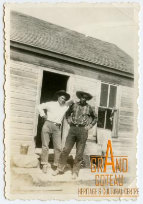 Photographic Print, 2 unidentified men in front of farmhouse