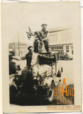 Photograph, Hymie Hanft and Tom Voll in clown costumes, posed on Hymie's decorated Essex Car, July 1945