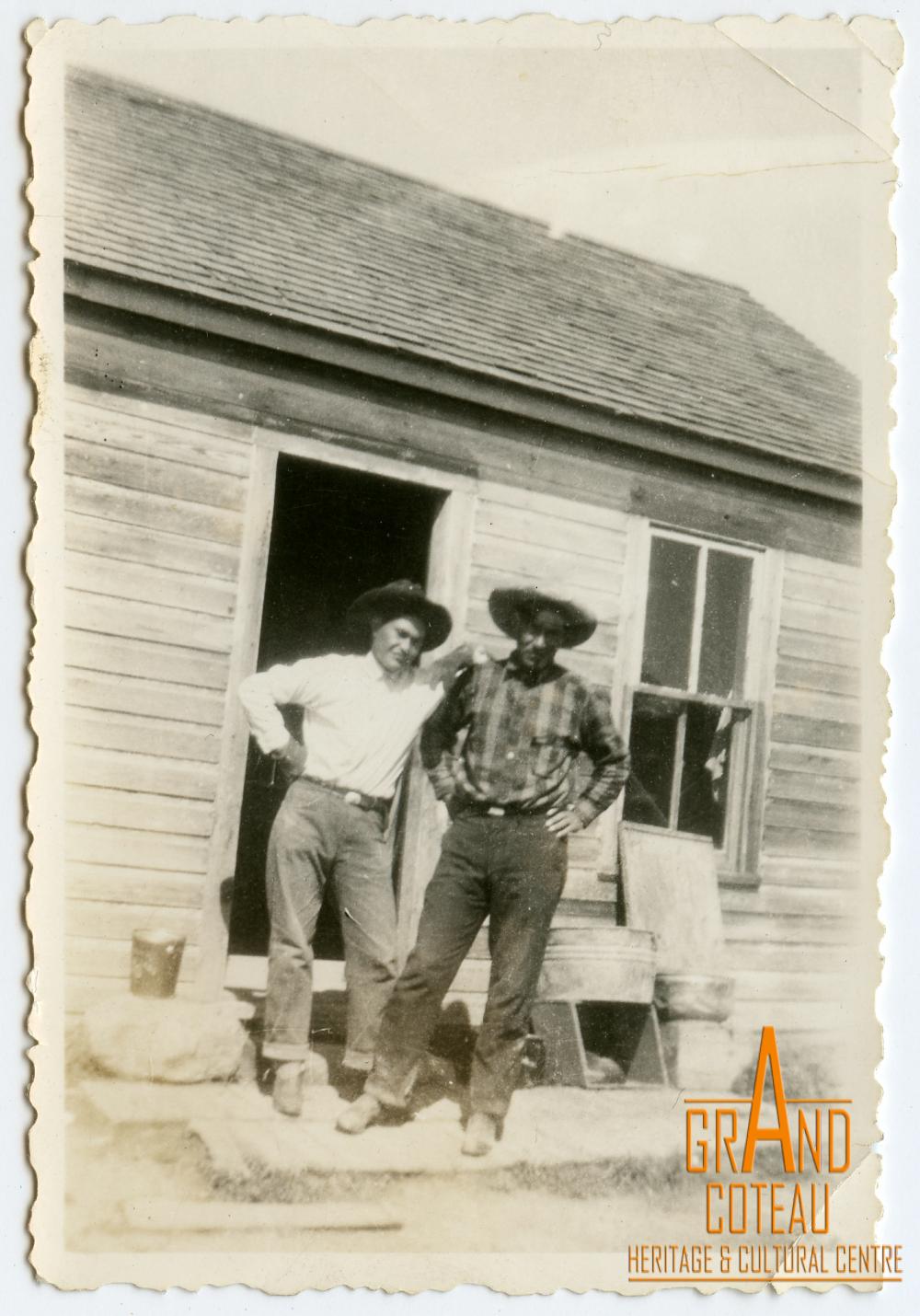 Photographic Print, 2 unidentified men in front of farmhouse