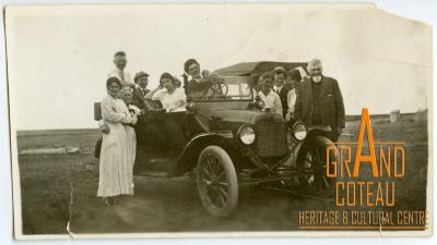 Photographic Print, unidentified group of people posing in and around a vehicle