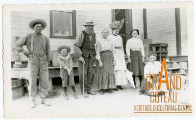 Photographic Print, unidentified group of people posing outside a house