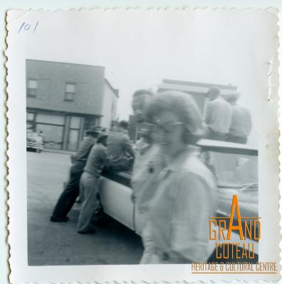 Photographic Print, unidentified people on street and in back of truck