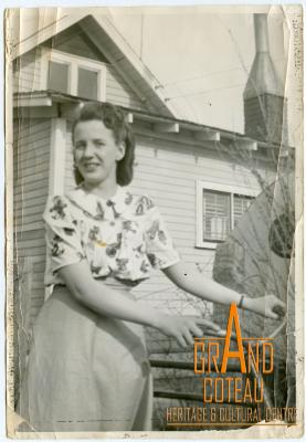 Photographic Print, unidentified woman posing with bicycle in front of house