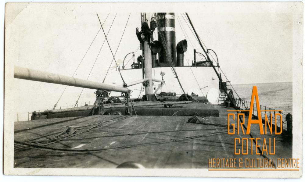 Photographic Print, Deck of a ship with three unidentified men in the rigging.