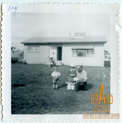 Photographic Print, man, woman and children posing on lawn in front of house