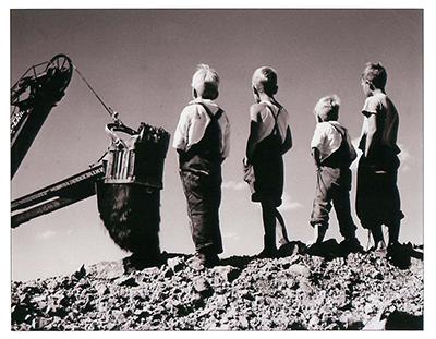 SK: Estevan area - Young lads watch a giant dragline at a Bienfait open-pit coal mine.
