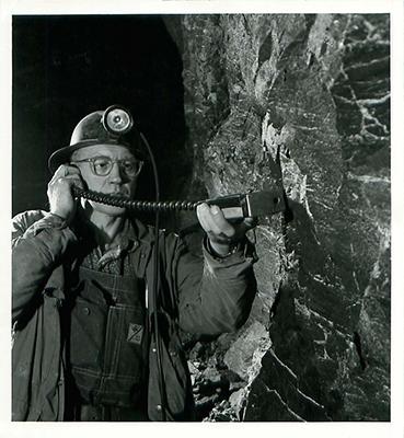SK: Beaverlodge area- Safetyman checks for radiation with Geiger counter at Eldorado Mining.