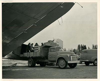 SK: Beaverlodge Airport - Supplies being unloaded from a DC-3 aircraft