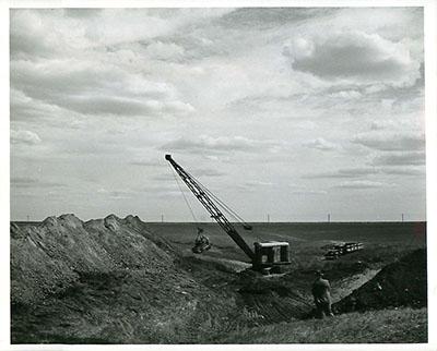 SK: Moose Jaw area -- Farmer has hired a dragline contractor to dig a dugout to hold water for his cattle.