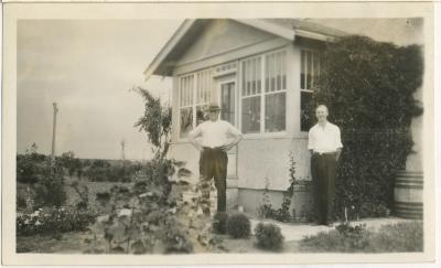 Photograph, Albert 'Doc' Hanft and son Leonard 'Hymie', in front of their farmhouse, 1932