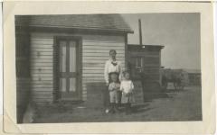 Photograph, Leonard 'Hymie' Hanft, mother Martha Hanft, and Miss Gerber in front of farm house