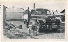 Photograph, young children Larry and Lana Hanft washing their father Len Hymie Hanft's truck, 1953