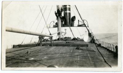 Photographic Print, Deck of a ship with three unidentified men in the rigging.