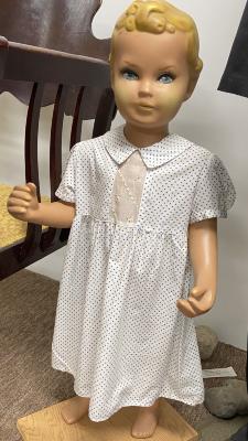 White child's dress with blue polka dots