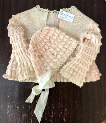 Child's knitted pink sweater and bonnet from the Walter Lindsay house