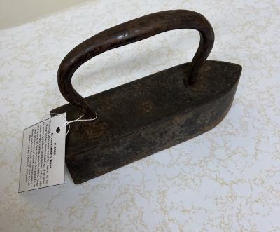 Dressmaker's Iron  - This flat iron was used by my grandmother Mrs. A. G. Olson in her dress making. She was an accomplished seamstress when she came to the Ohlan area in 1890. She did much of her sewing for people in the Whitewood Area, commuting there on horseback from her home