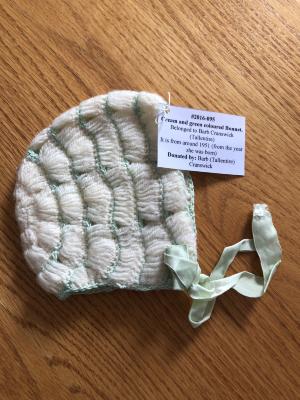 Cream and green coloured Bonnet - Belonged to Barb Cranswick (Tallentire)  It is from around 1951 (from the year she was born)