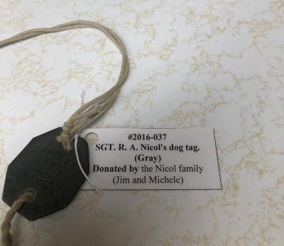 SGT. R. A. Nicol's dog tag. (Gray)