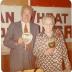 Colour photo of Ruth and Everett Baker with plaques presented from Saskatchewan Wheat Pool