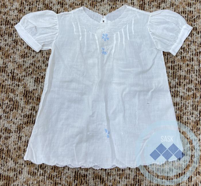 Child's shirt with two blue flowers on front