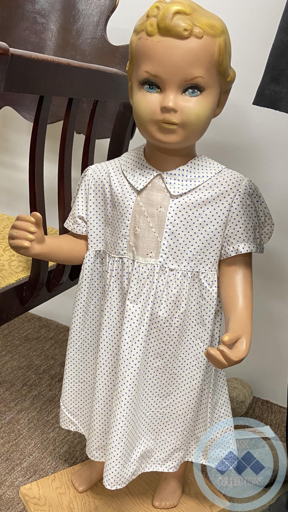 White child's dress with blue polka dots