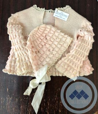 Child's knitted pink sweater and bonnet from the Walter Lindsay house
