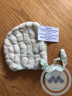 Cream and green coloured Bonnet - Belonged to Barb Cranswick (Tallentire)  It is from around 1951 (from the year she was born)