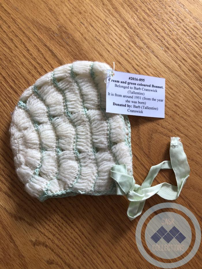 Cream and green coloured Bonnet - Belonged to Barb Cranswick (Tallentire)  It is from around 1951 (from the year she was born)