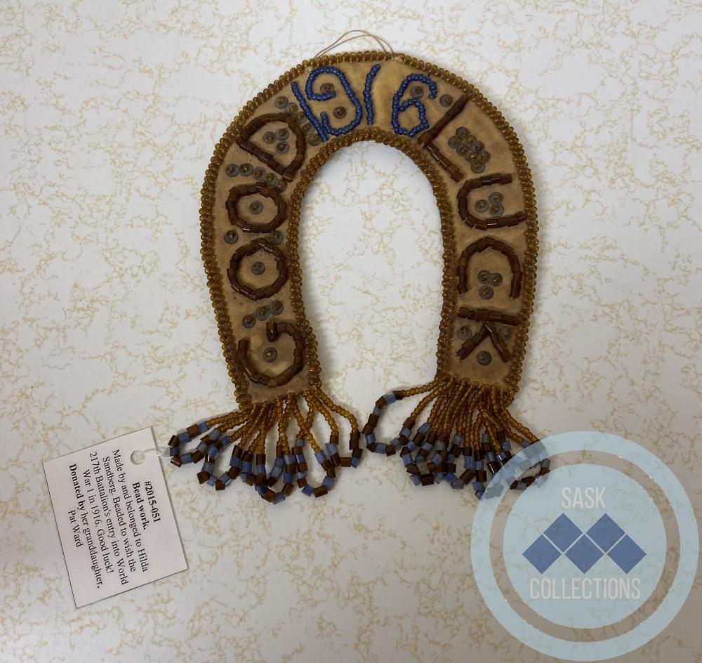 Bead work. Made by and belonged to Hilda Sandberg. Beaded to wish the 217th Battalion's entry into World War 1 in 1916. Good luck!